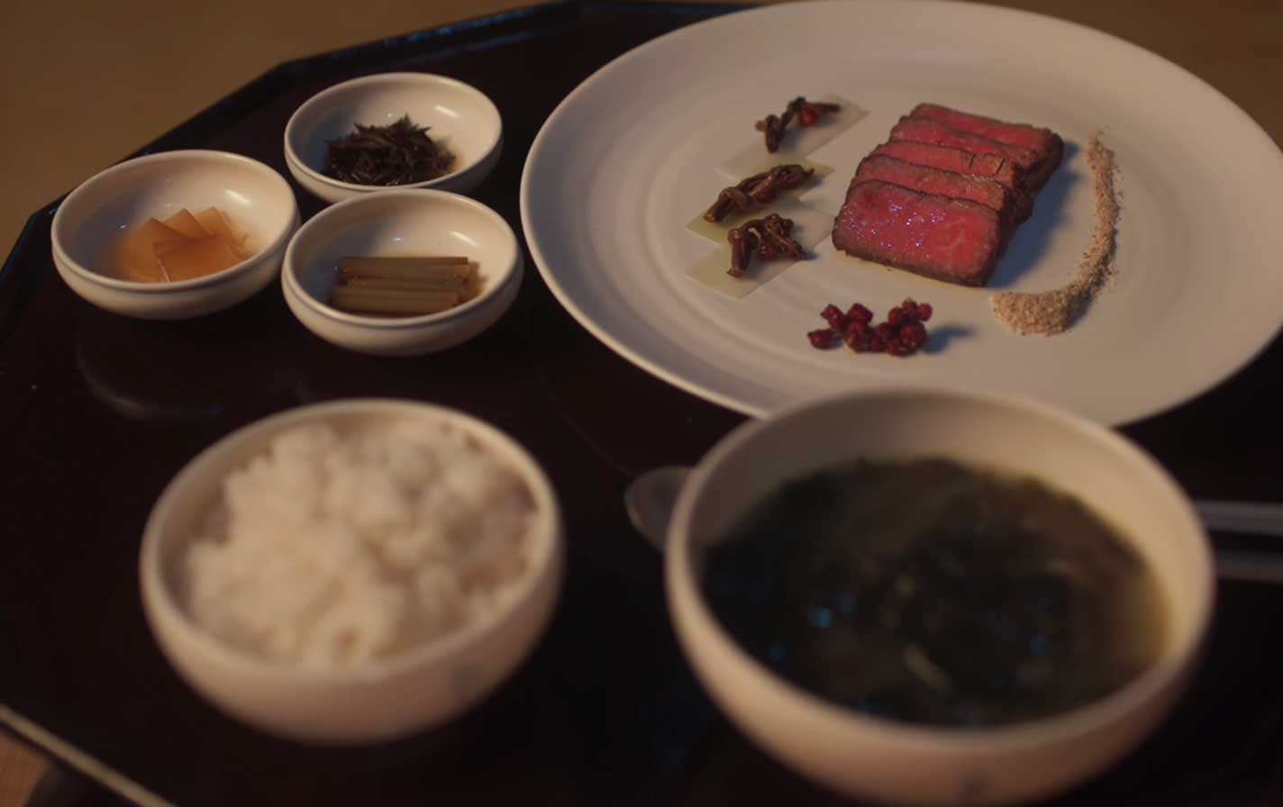 Platillo-Nº2-—-Cocina-al-vacío Dos lightsticks ARMY Bomb de BTS sostenidos en alto durante un concierto, con el escenario iluminado al fondo.